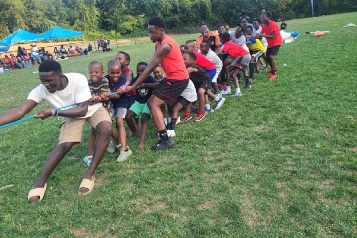 The youth taking part in the tug of war (rope pulling game) The youth taking part in the tug of war (rope pulling game)